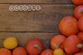 Pumpkins on wooden planks with word OCTOBER Royalty Free Stock Photo