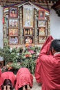 Punakha, Bhutan - September 11, 2016: Bhutanese monks in traditional dress praying to Lam Drukpa Kinley in Chimi Lhakhang, Bhutan Royalty Free Stock Photo