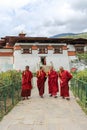Punakha, Bhutan - September 11, 2016: Four monks walking in the garden of Chimi Lhakhang (Monastery of Fertility), Bhutan