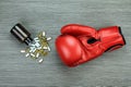 Punch away the illness, boxing gloves and drug capsules.