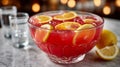 A punch bowl with red drink and citrus slices on a table. Royalty Free Stock Photo