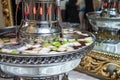 A punch fountain with lights and red drink on a table.