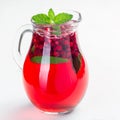 Punch or limeade with lingonberry and lime in a  pitcher on a gray background, square, closeup Royalty Free Stock Photo