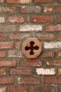 Punched cement quatrefoil octagon detail in red and white brick wall with gray mortar Royalty Free Stock Photo