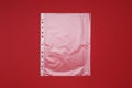 Punched pocket on red background, top view Royalty Free Stock Photo