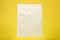 Punched pocket on yellow background, top view Royalty Free Stock Photo
