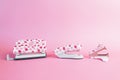 Puncher, stapler and staple remover, with pink dots on a pink background. Office and school supplies concept. Copy-space