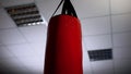 Punching bag under ceiling in office, overcoming business difficulties concept Royalty Free Stock Photo