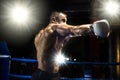 Punching boxer on boxing ring