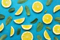 Punchy pastel background with lemon slices and mint leaves. Summer colorful pattern. Flat lay style.