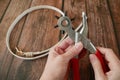 Puncture holes in the strap using a punch and belt on wooden background. Belt Hole Puncher Power Assist Heavy Duty Revolving Royalty Free Stock Photo