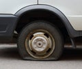 Punctured wheel of a small car Royalty Free Stock Photo