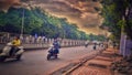 Pune city trafic cloud sky colour busy people bike road tree greem