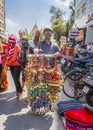 PUNE, INDIA - MARCH 14, 2019: Souvenir seller and passers-by in Pune, India