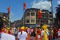 Pune, India - September 4, 2017: Dhol tasha pathak dancing with three orange flags celebrating Ganapati visarjan festival.