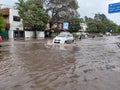 PUNE, Maharashtra, 03 Dec 2021, Peoples drive through waterlogged during heavy rain at BT Kawde Road in Pune. D, flooded roads Royalty Free Stock Photo