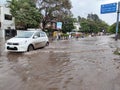 PUNE, Maharashtra, 03 Dec 2021, Peoples drive through waterlogged during heavy rain at BT Kawde Road in Pune. D, flooded roads Royalty Free Stock Photo