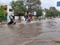 PUNE, Maharashtra, 03 Dec 2021, Peoples drive through waterlogged during heavy rain at BT Kawde Road in Pune. D, flooded roads Royalty Free Stock Photo