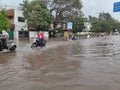 PUNE, Maharashtra, 03 Dec 2021, Peoples drive through waterlogged during heavy rain at BT Kawde Road in Pune. D, flooded roads Royalty Free Stock Photo