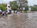 PUNE, Maharashtra, 03 Dec 2021, Peoples drive through waterlogged during heavy rain at BT Kawde Road in Pune. D, flooded roads Royalty Free Stock Photo