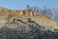 Excavator of Volvo company digging for road widening