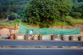 Pune, Maharashtra, India - October 4th, 2017 : Motion blur image of an old bicycle rider wearing helmet for safety on a way fo