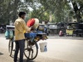 A man selling Indian street food chole kulche