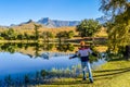 A Punjabi Indian young man posing on a lake with reflection in Royal Natal National park