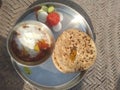 Punjabi thali of potatoes vegitable , butter and sliced of tomato, radish with two chapati