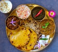 Punjabi vegetarian thaali meals served traditionally in brass plate