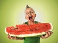 Punk boy eating a big slice of watermelon Royalty Free Stock Photo