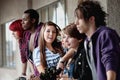 Punk girl looks to camera and poses among friends