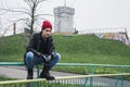 Punk guy posing in a city park