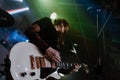 A punk girl playing a guitar in a concert Royalty Free Stock Photo