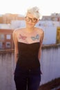 Punk, tattoo and portrait of woman in city for creative, urban and culture. Happy, pride and identity with rebel female