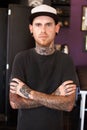 Punk, tattoos and portrait of a male artist standing with crossed arms for confidence in his studio. Serious, cool and Royalty Free Stock Photo
