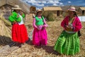 Puno, Peru - circa June 2015: Women singing at Uros floating island and village on Lake Titicaca near Puno, Peru Royalty Free Stock Photo