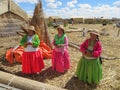 Puno, Peru - circa June 2015: Women singing at Uros floating island and village on Lake Titicaca near Puno, Peru Royalty Free Stock Photo