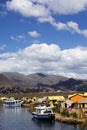 Puno, Peru - Traditional Totora boat with tourists on Lake Titicaca near the floating islands of Uros, Puno, Peru, Royalty Free Stock Photo