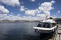 Puno, Per Traditional Totora boat with tourists on Lake Titicaca near the floating islands of Uros, Puno, Peru, Royalty Free Stock Photo