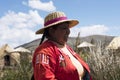 Puno Peru Lake Titicaca with Totoras Island with women from the Uros culture with their typical clothes and straw hats