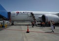 Passengers disembark Latam Airlines plane after landing with gusting wind more than 75 miles per hour at Punta Arenas Airport