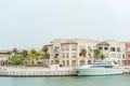 PUNTA CANA, DOMINICAN REPUBLIC - JUNE 18, 2015: Local Architecture with Palm Tree and yacht in water. Luxury Class in Punta Cana,