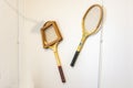 Punta Umbria, Huelva, Spain - April 27, 2022: Two old tennis rackets hanging on a wall Inside of a english summer house in Punta