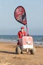 Punta Umbria, Huelva, Spain - August 7, 2020: A female street vendor selling ice cream in the beach. Seller is wearing protective