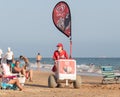 Punta Umbria, Huelva, Spain - August 7, 2020: A female street vendor selling ice cream in the beach. Seller is wearing protective