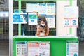 Punta Umbria, Huelva, Spain - August 7, 2020: Woman in a information point in the street