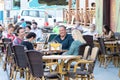 Punta Umbria, Huelva, Spain - July 3, 2020: People sitting in terrace of a cafe and bar in street calle Ancha of Punta Umbria