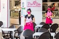 Punta Umbria, Huelva, Spain - June 3, 2020: A woman waitress in a protective mask is going to clean the tables of Porto Bello ice