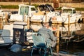 Puntone Scarlino, Maremma Tuscany, Italy. Senior man fishing at sunset on the small boat area Royalty Free Stock Photo